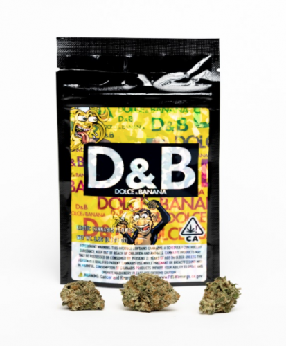 this is a photo of the dolce & banana strain from golden state banana where the nugs are in front of the black and gold bag