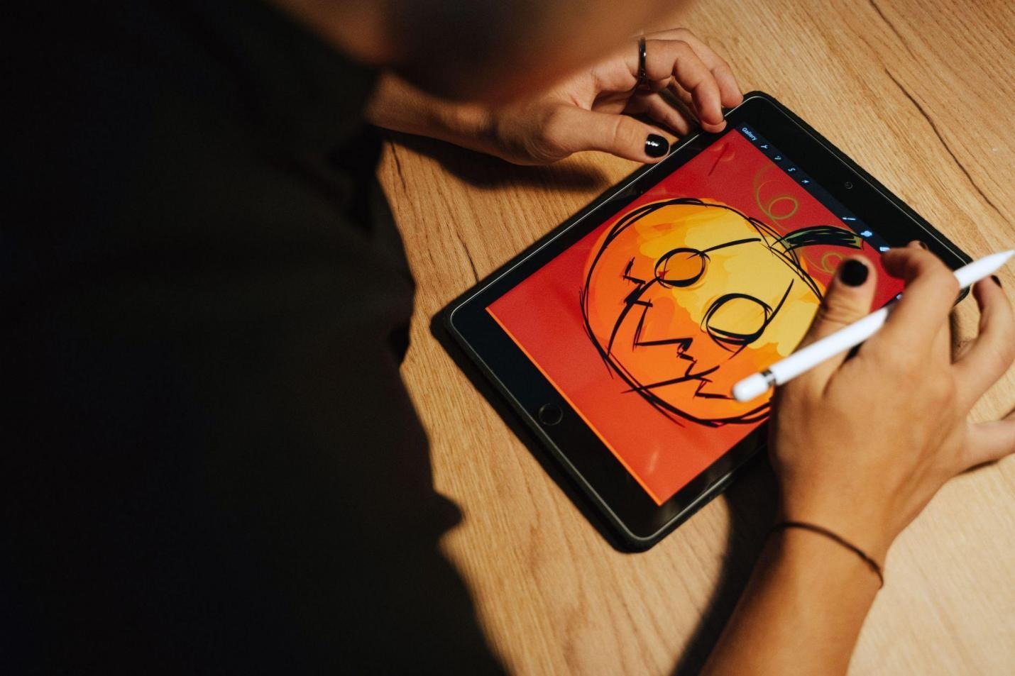 Digital artist sketching a colorful character illustration on a tablet. Photo credit: Vograce